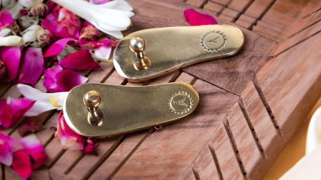 Brass paduka placed on flooring