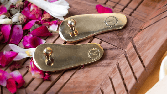 Brass paduka placed on flooring