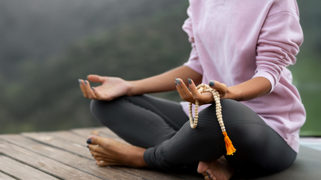 a girl doing meditation holding jaap mala