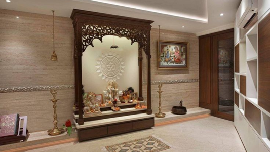 Modern home mandir with carved wooden temple, brass lamps, Hindu idols, and peaceful prayer room decor