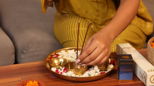 A girl preparing pooja arti thali