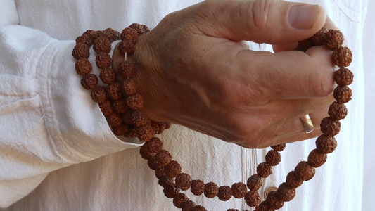 A person holding jaap mala