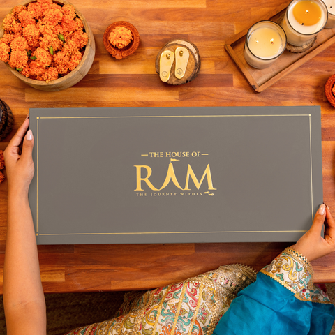 A hands-on display of a luxurious gift box for Diwali, surrounded by marigold flowers and a festive ambiance.
